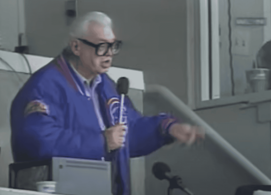Harry Caray at the microphone, embodying the spirit of baseball broadcasting.
